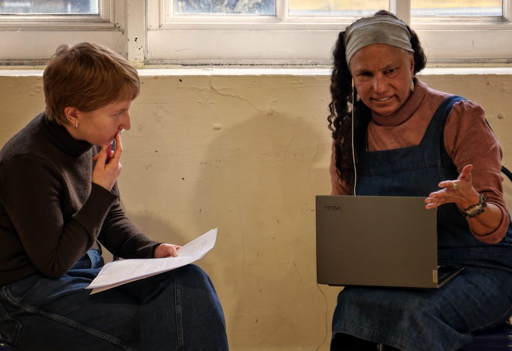 Grace sits together with Maria at work.